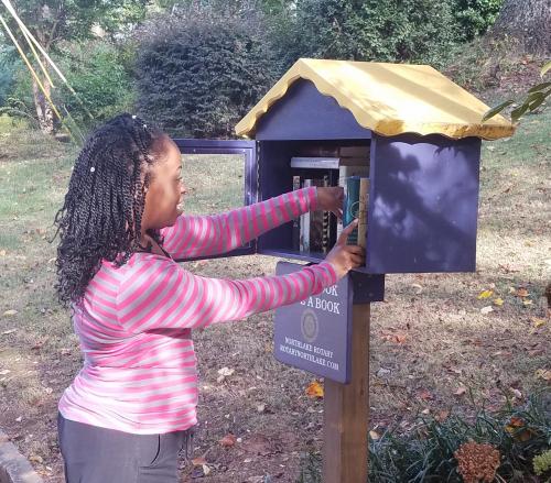 Tia stops by Tucker Rotary's Little Free Library.jpg